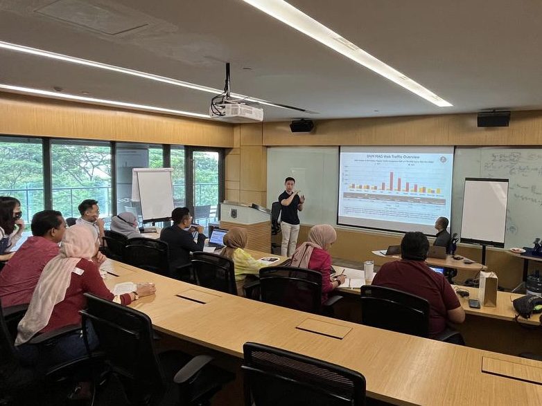 OnceMore Digital team presenting website traffic data to a client during a strategy session in a Kuala Lumpur meeting room